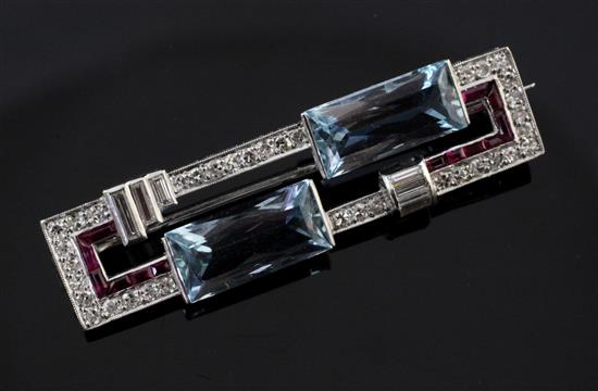 A 1930s/1940s Art Deco platinum, aquamarine, synthetic ruby? and diamond set bar brooch, 1.75in.